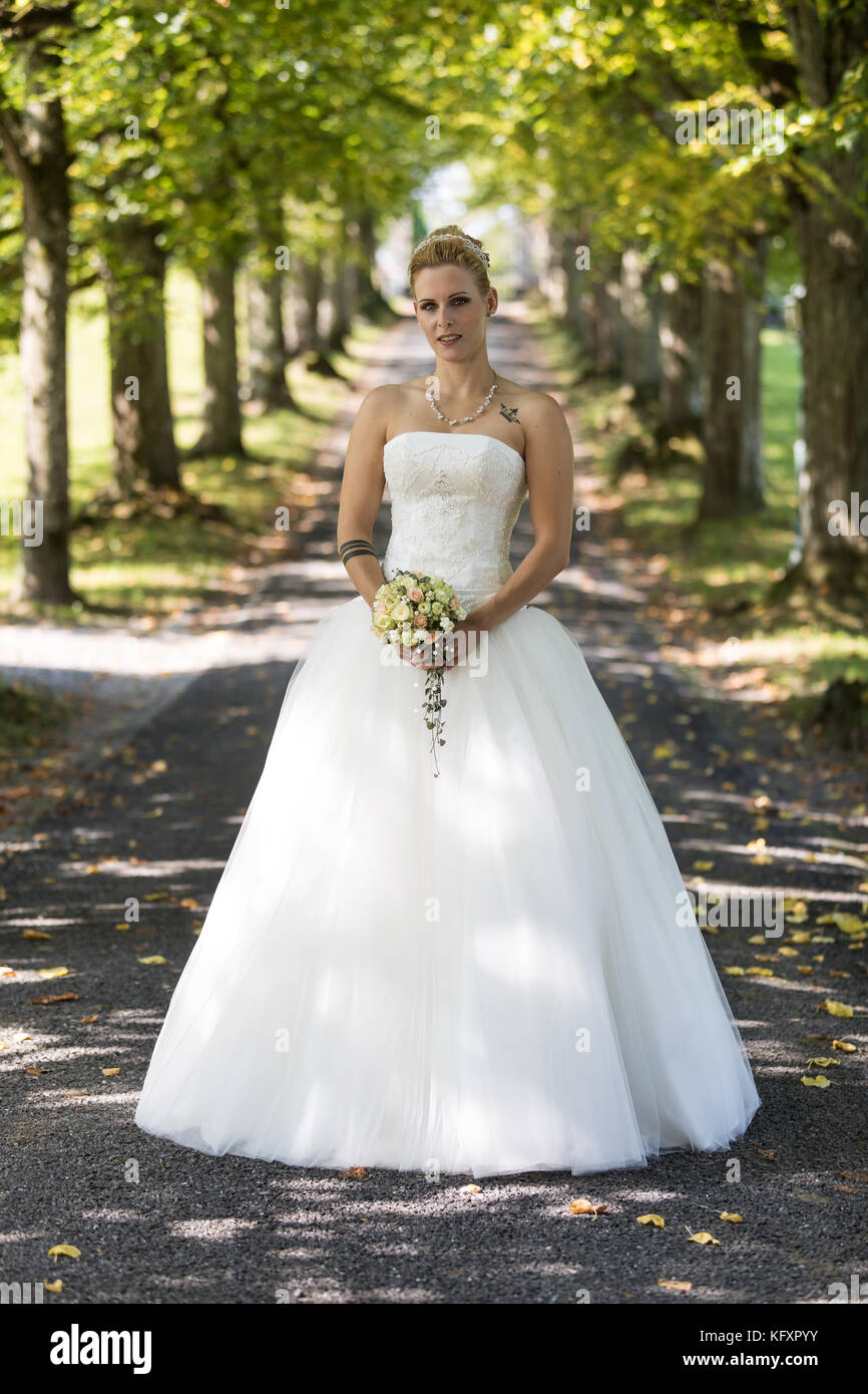 Young blonde woman in a white wedding dress, Switzerland Stock Photo