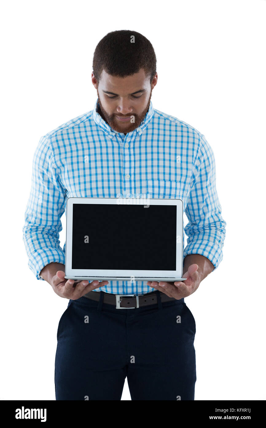 Male executive holding laptop against white background Stock Photo - Alamy