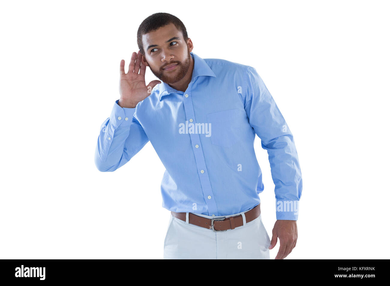 Young male executive listening secretly with hands behind her ears Stock Photo