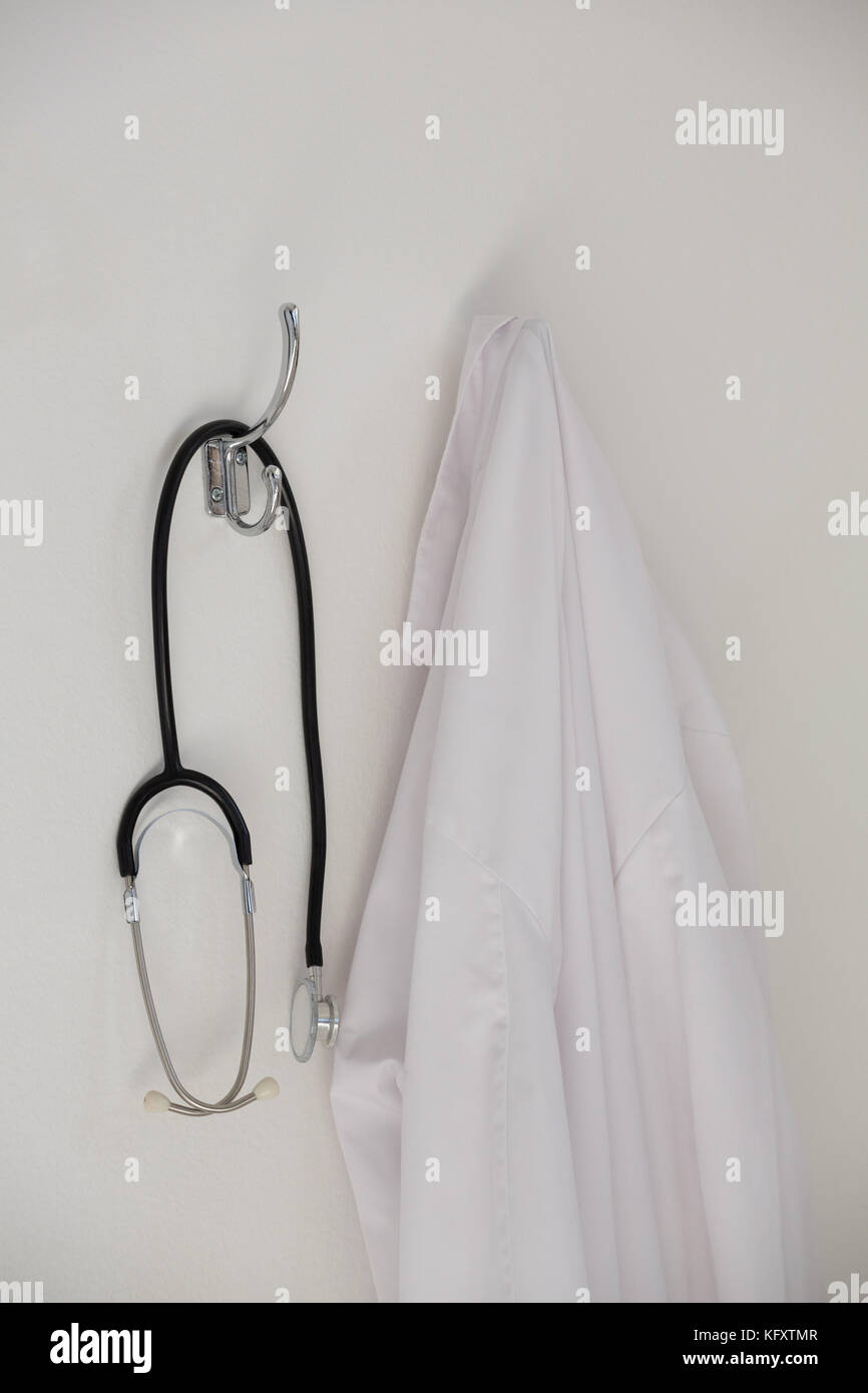 Close-up of laboratory coat and stethoscope hanging on hook Stock Photo