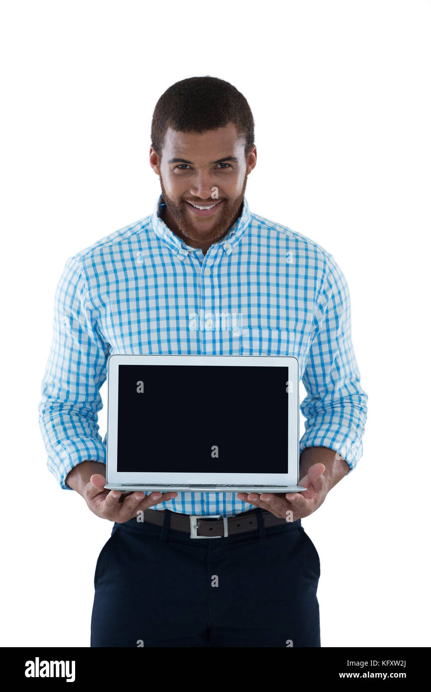 Male executive holding laptop against white background Stock Photo - Alamy
