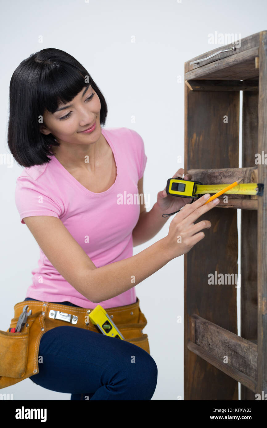https://c8.alamy.com/comp/KFXWB3/woman-measuring-furniture-with-tape-measure-against-white-background-KFXWB3.jpg