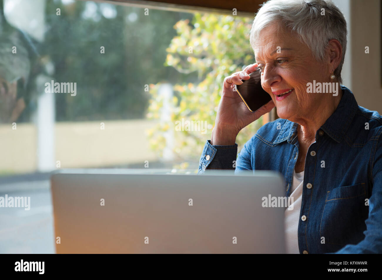 Senior woman talking on mobile phone in cafÃƒÂ© Stock Photo - Alamy
