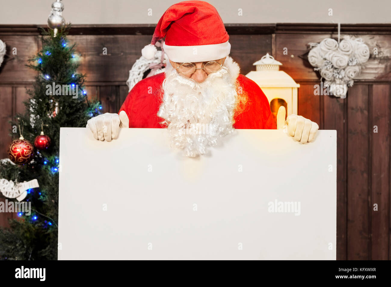 santa claus showing a blank billboard in her home Stock Photo - Alamy
