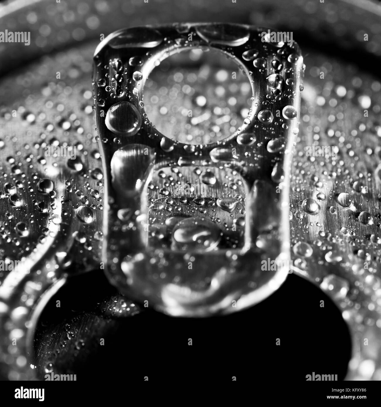 The ring pull of a soft drinks can that's been covered in water droplets. Stock Photo