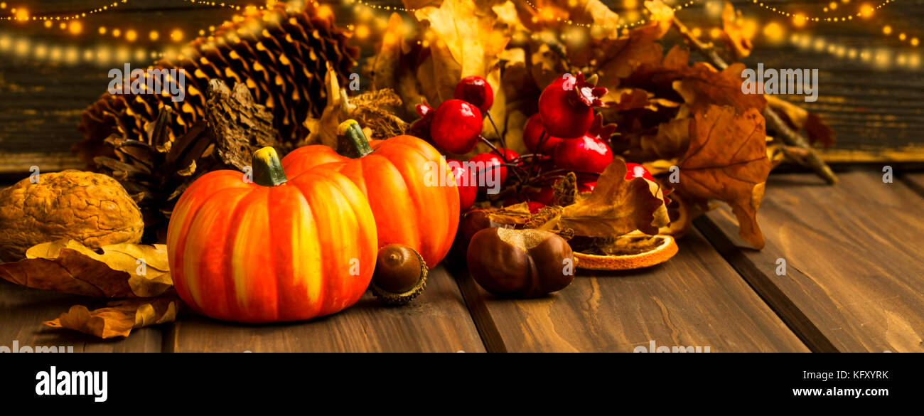 Festive autumn pumpkins and decorations with festive lights, fall season deco concept Stock Photo
