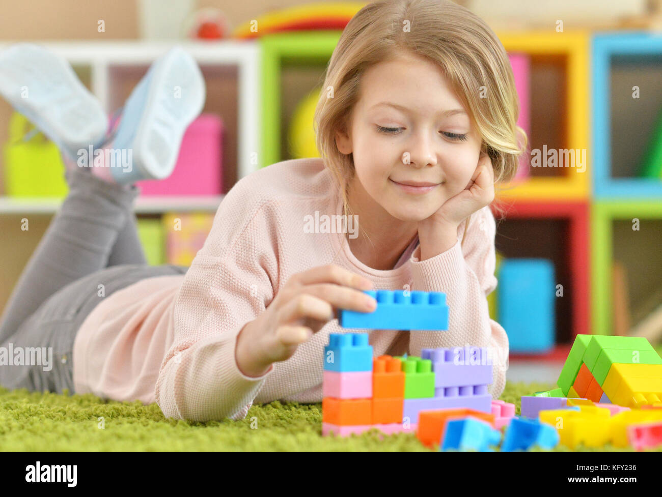 little girl with colorful plastic blocks Stock Photo - Alamy