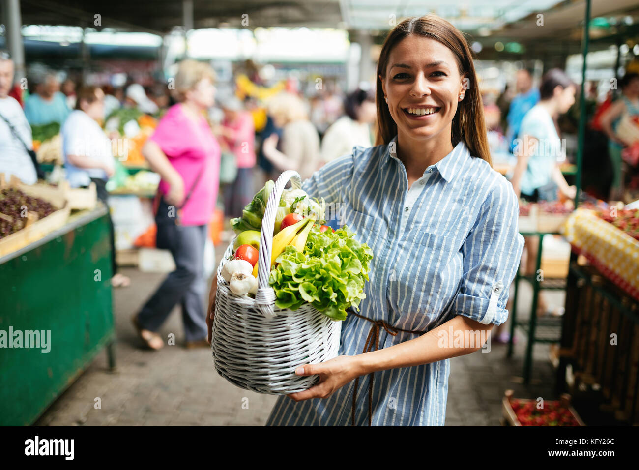 Portrait of beautiful woman holding shopping basket Stock Photo - Alamy