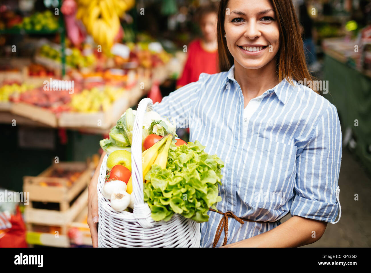 Portrait of beautiful woman holding shopping basket Stock Photo - Alamy