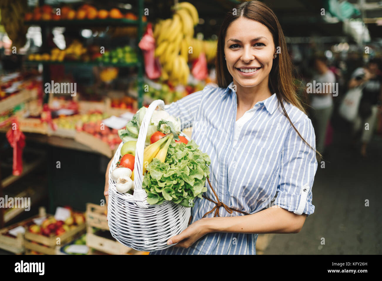 Portrait of beautiful woman holding shopping basket Stock Photo - Alamy