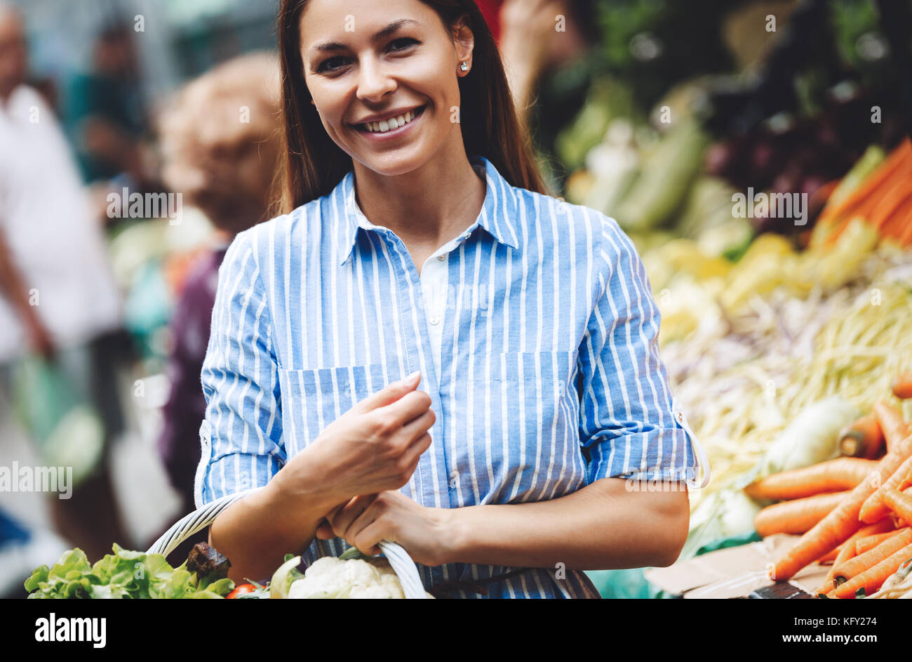 Portrait of beautiful woman holding shopping basket Stock Photo - Alamy
