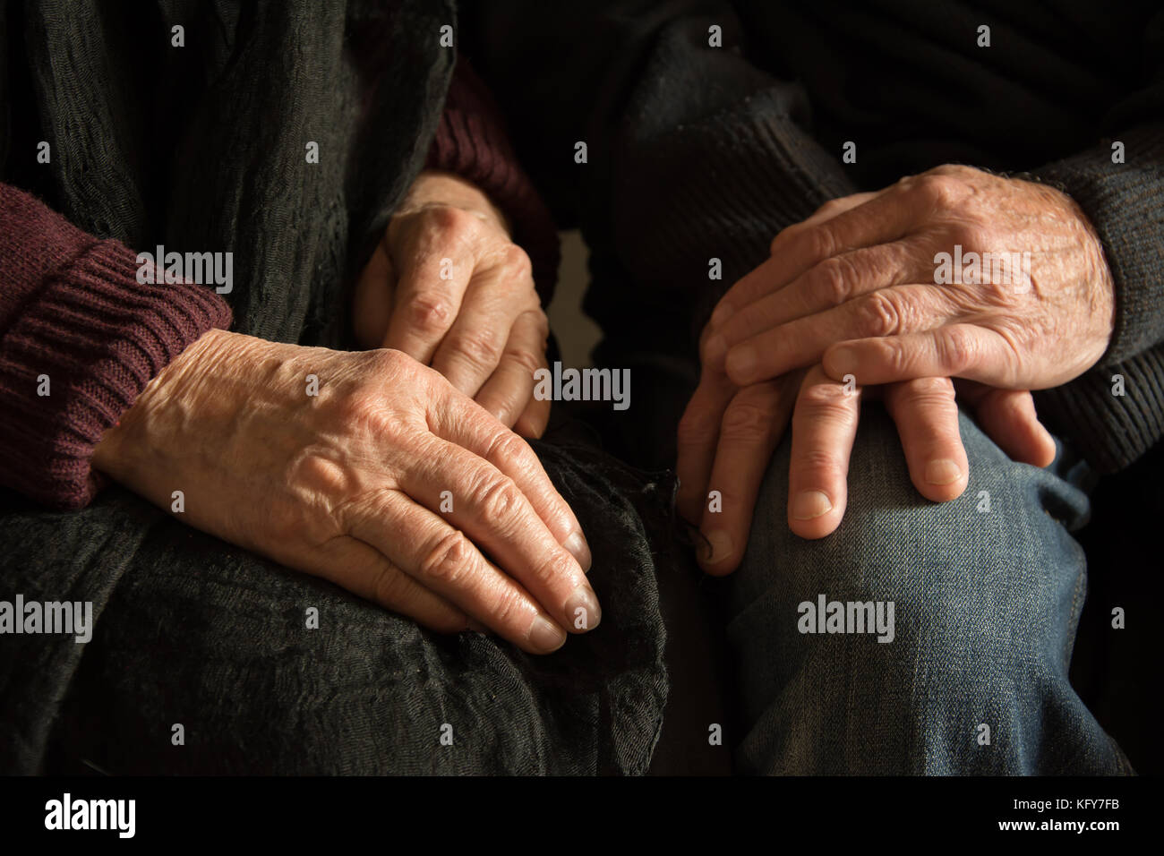 Hands of an old woman and an old man sitting together Stock Photo