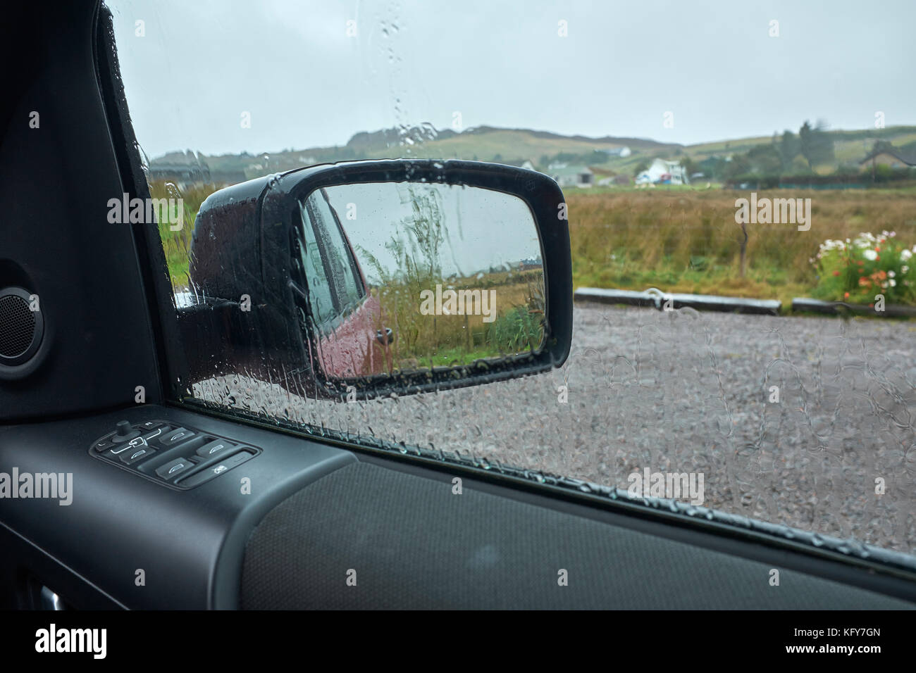 Scottish rain reflected in rain-soaked wing mirror and side window of Land Rover Freelander. Ormiscaig, Aultbea. Achnasheen West Coast. Scotland Stock Photo