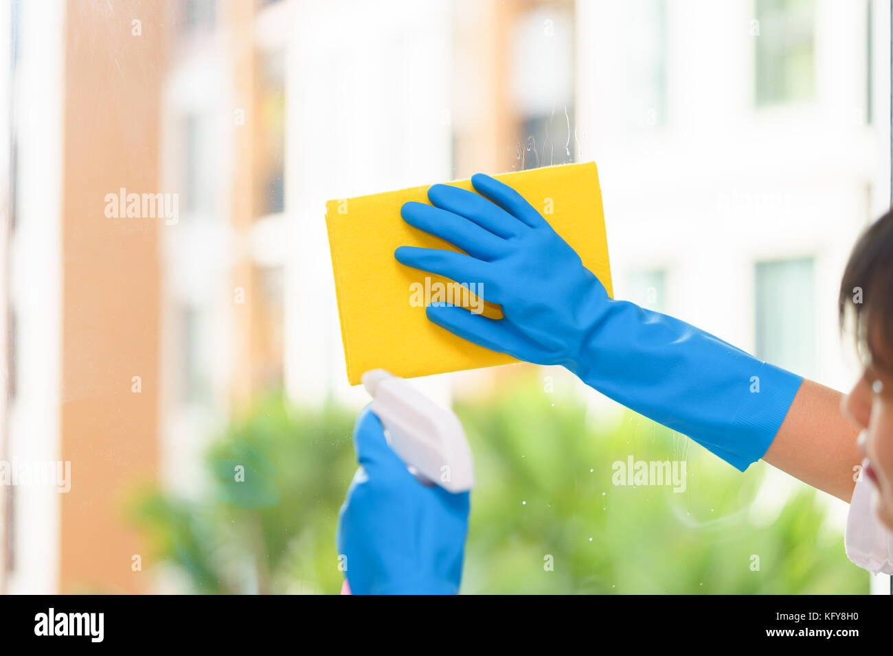 Housekeeper cleaning mirror with yellow cloth Stock Photo Alamy