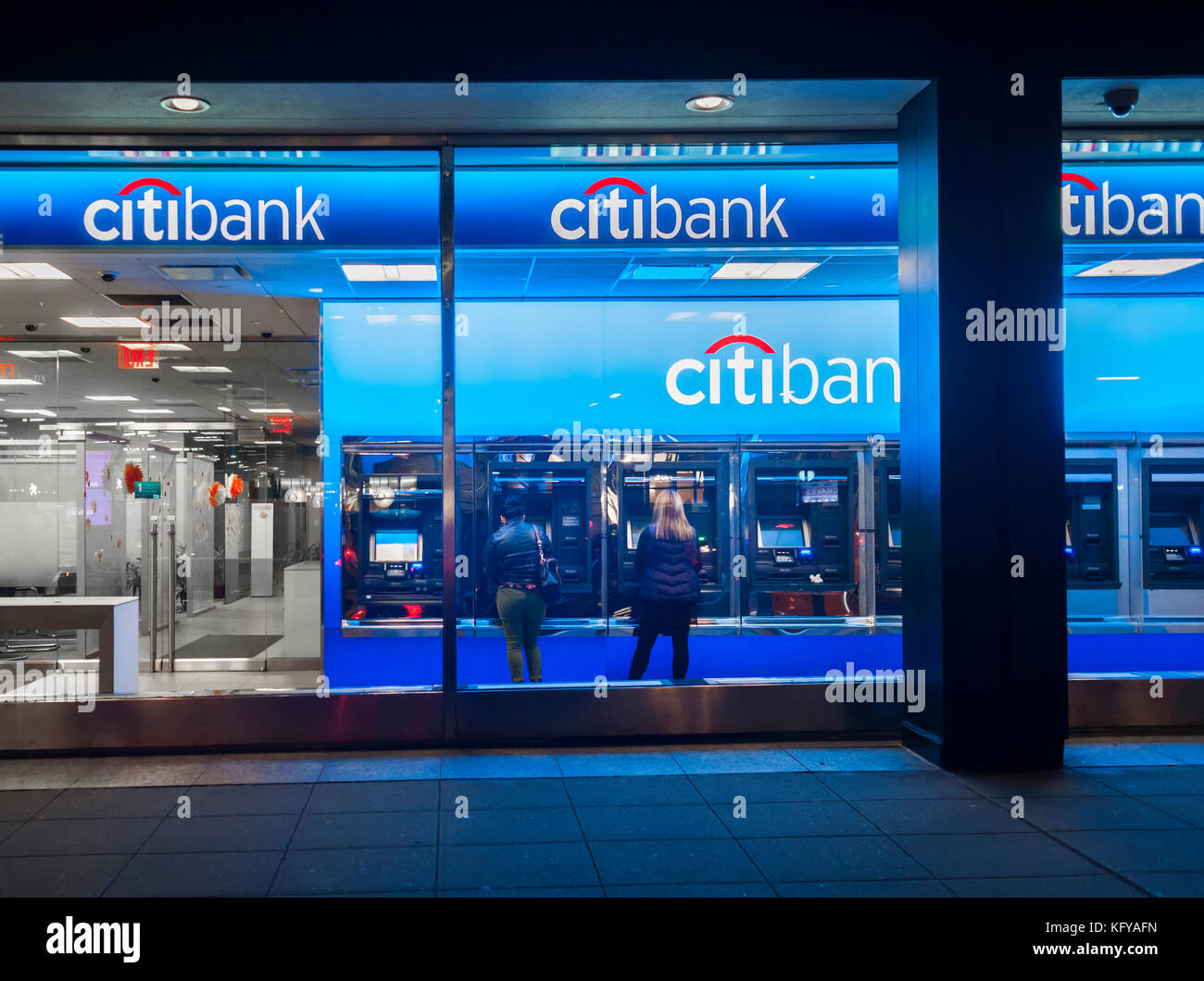 Customers use automated teller machines in a Citibank branch in Midtown