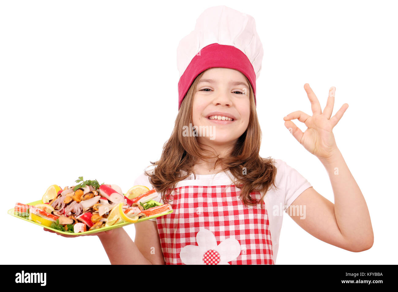 happy little girl cook with seafood and ok hand sign Stock Photo
