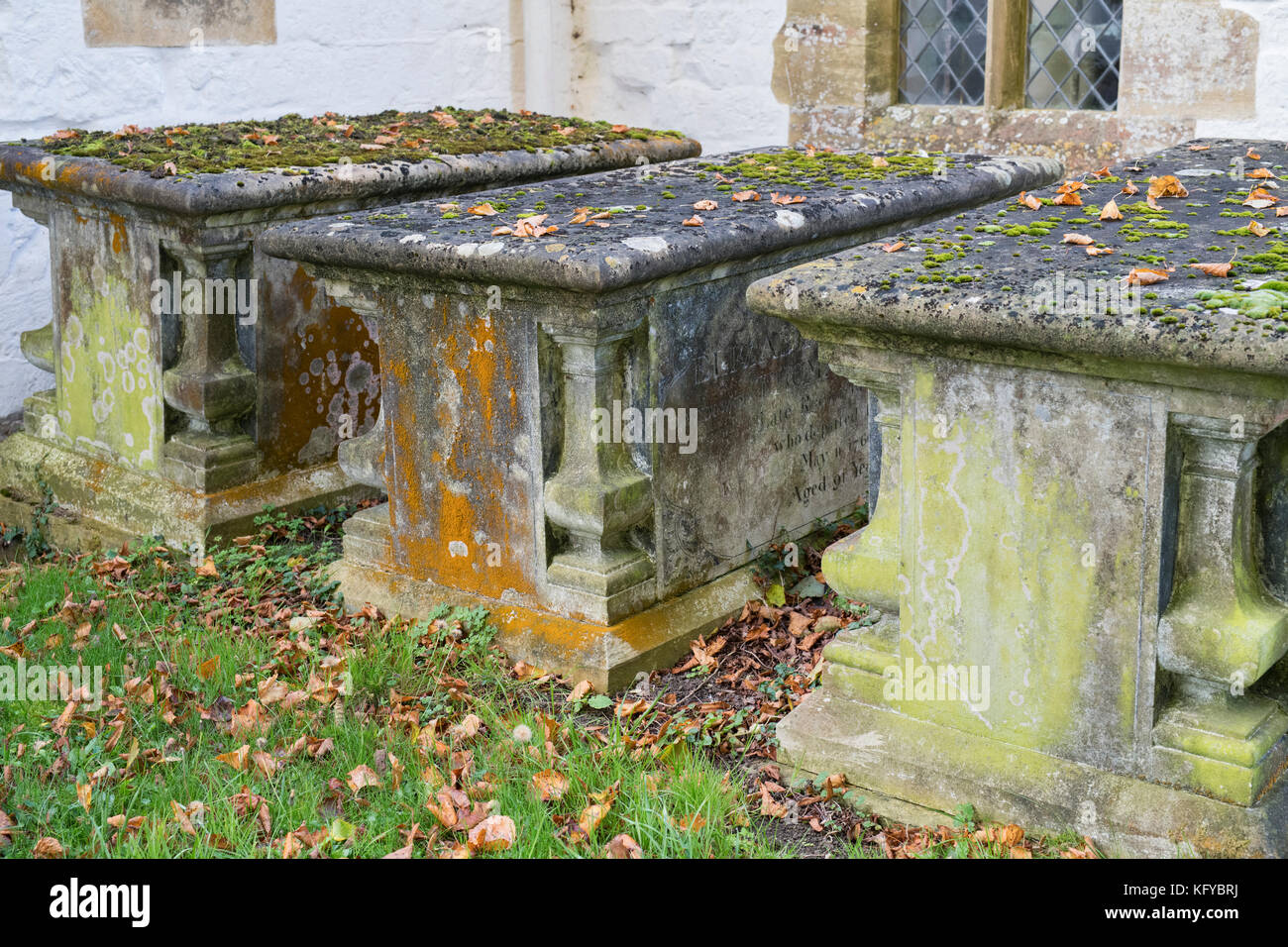 Tombs covered in algae in the 13th century Church of St Swithun at Compton Beauchamp in autumn. Vale of White Horse, Oxfordshire, England Stock Photo