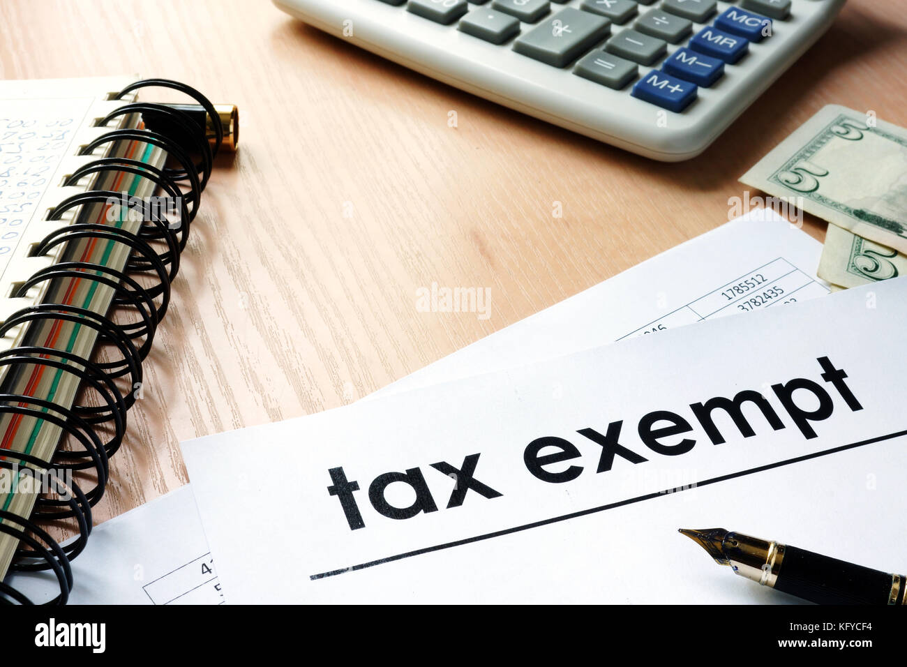 Documents with title tax exempt on an office table. Stock Photo