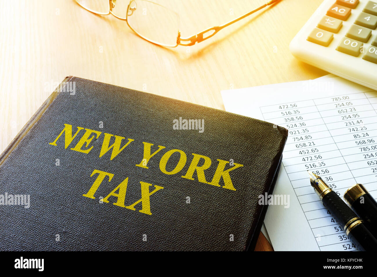 Book with title New York tax and calculator Stock Photo Alamy
