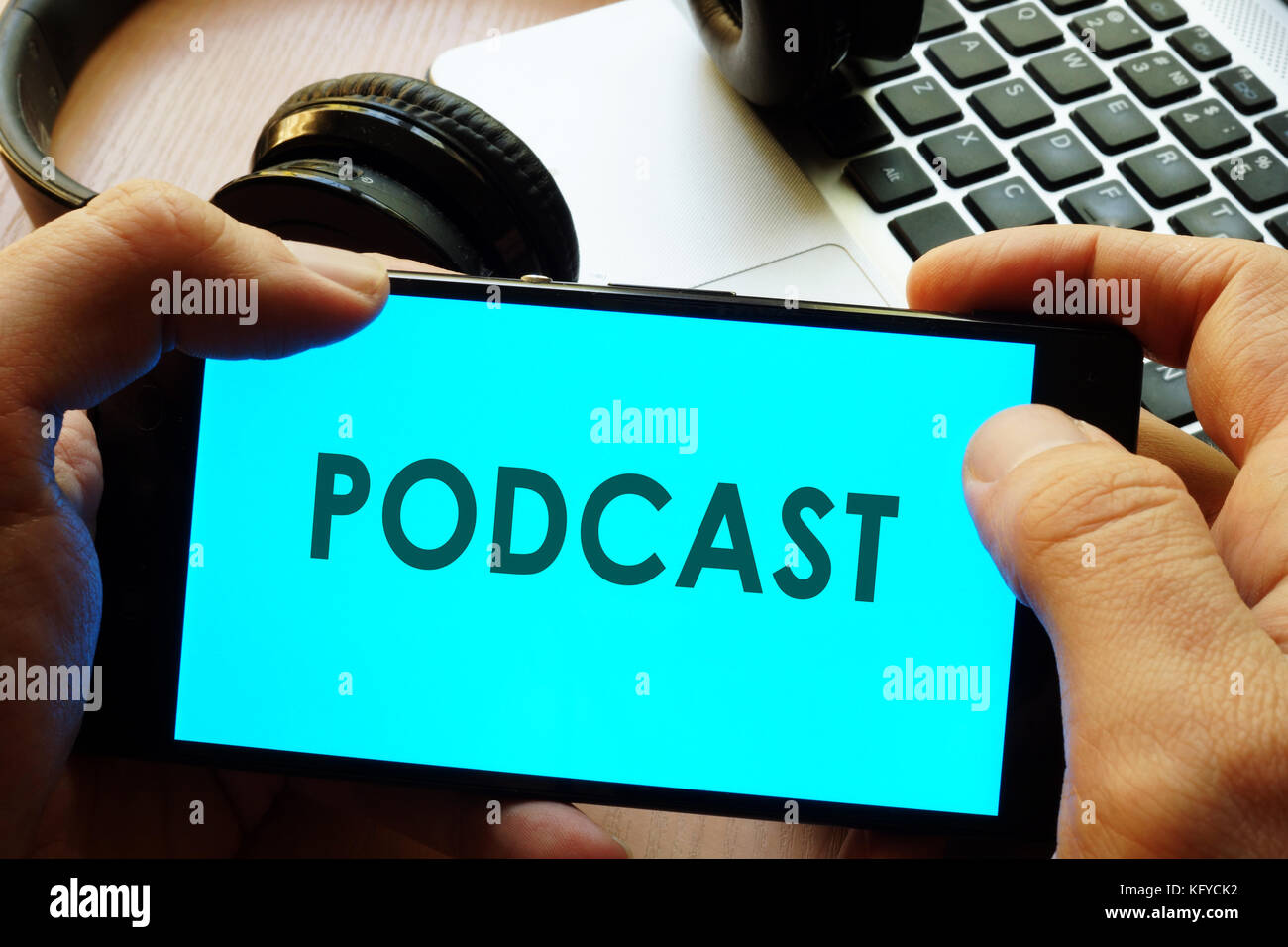 Hand holding smartphone with word podcast. Stock Photo