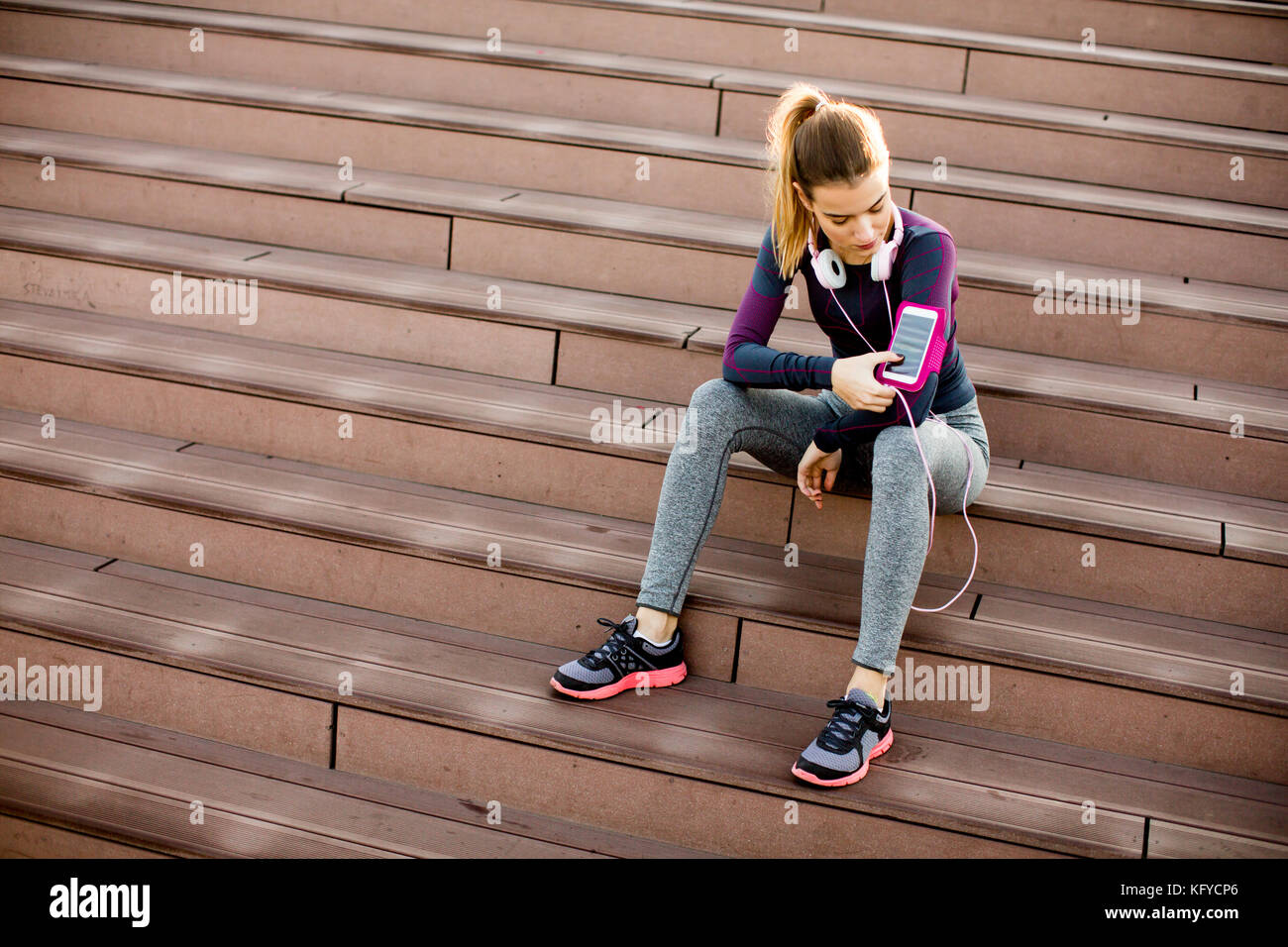 Young woman resting after jogging on stairs outdoor Stock Photo - Alamy