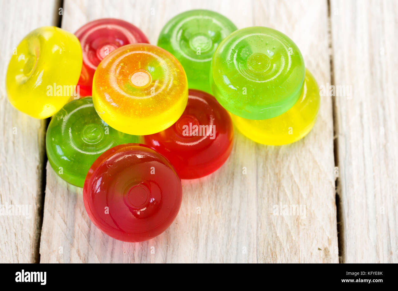 Red, green and yellow lollipops on a white background Stock Photo - Alamy