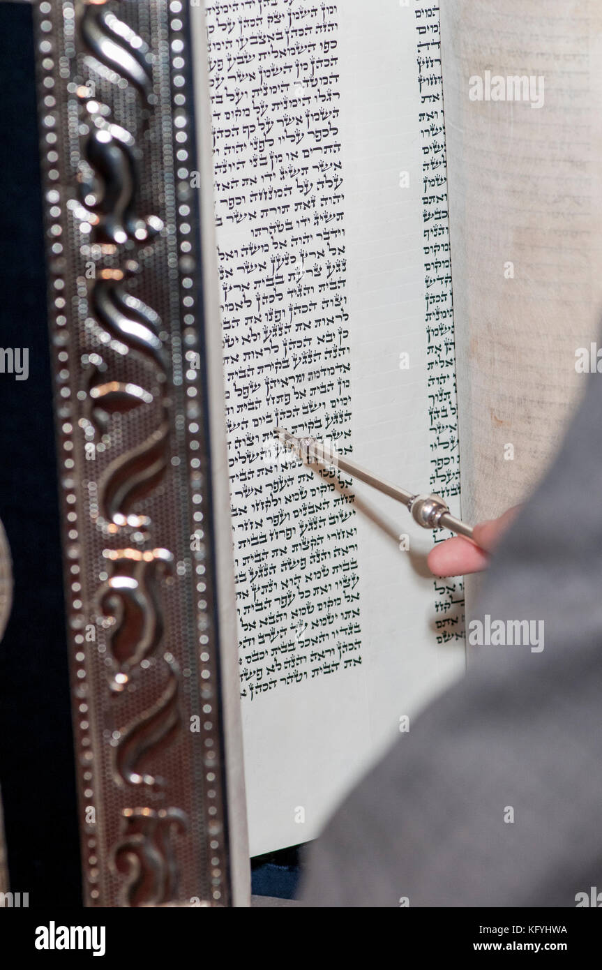 Minnetonka, Minnesota. 14 year old boy practicing for his Bar Mitzva at Bet Shalom Congregation Synagogue.  Reading a Torah scroll with a yad. Stock Photo