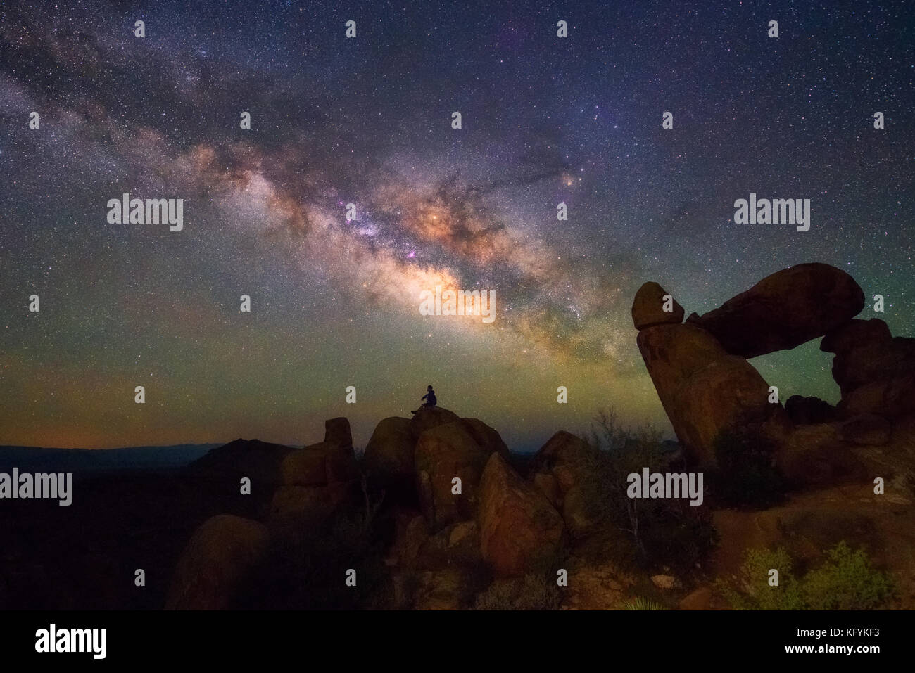 Human observing Milky way at Balanced Rock, Big Bend National park, Texas USA. Constellation and galaxy Stock Photo
