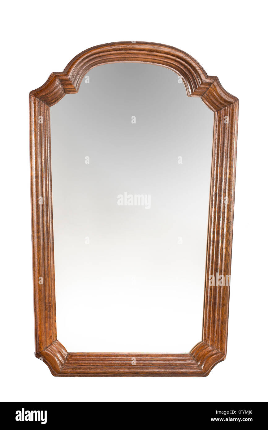 Antique mirror in wooden carved frame on the white background. Stock Photo