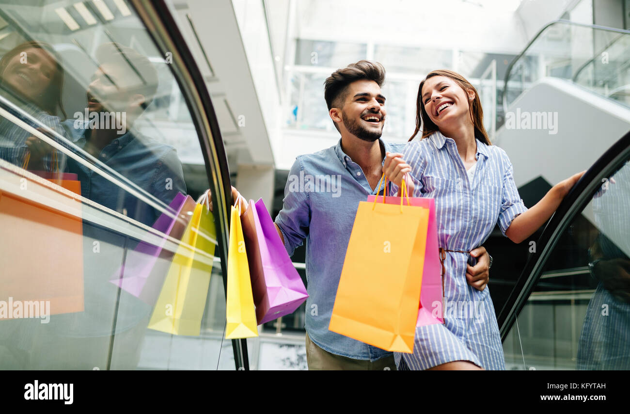 Happy attractive loving couple enjoy shopping together Stock Photo