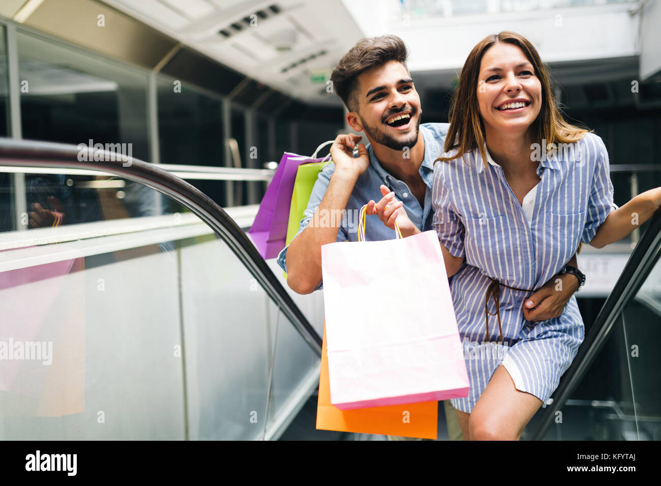 Happy attractive loving couple enjoy shopping together Stock Photo
