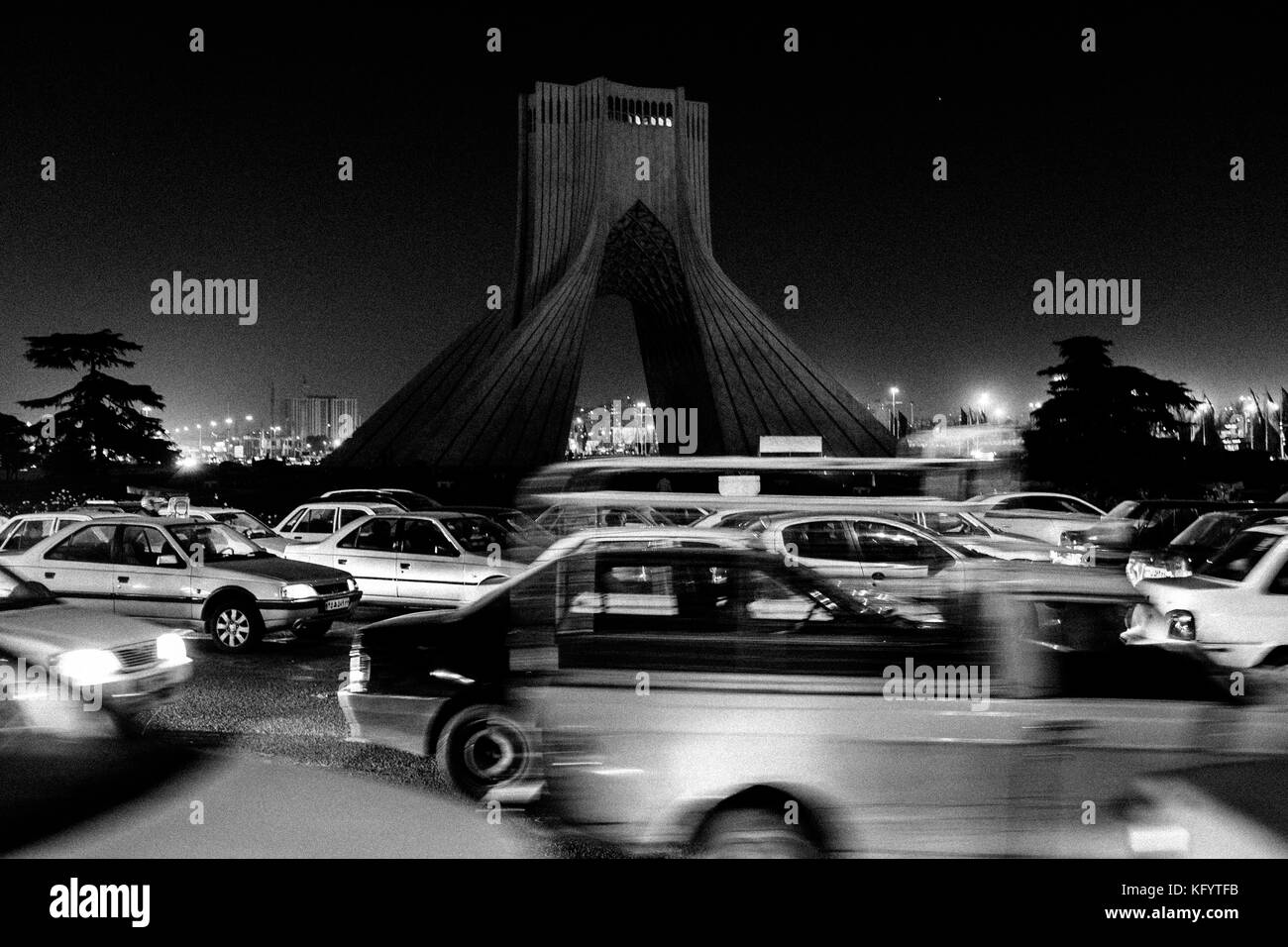Tehran, Iran - December 29, 2013. Heavy car traffic around the Azadi Tower in Tehran City. The Tower is also known as the Freedom or Liberty Tower. Stock Photo
