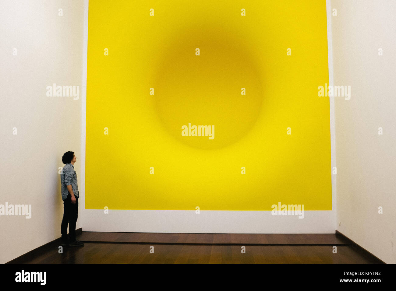 Istanbul, Turkey - January 21, 2014. A visitor is looking at Anish Kapoor's work Yellow at the Sakip Sabanci Museum in Istanbul. Stock Photo