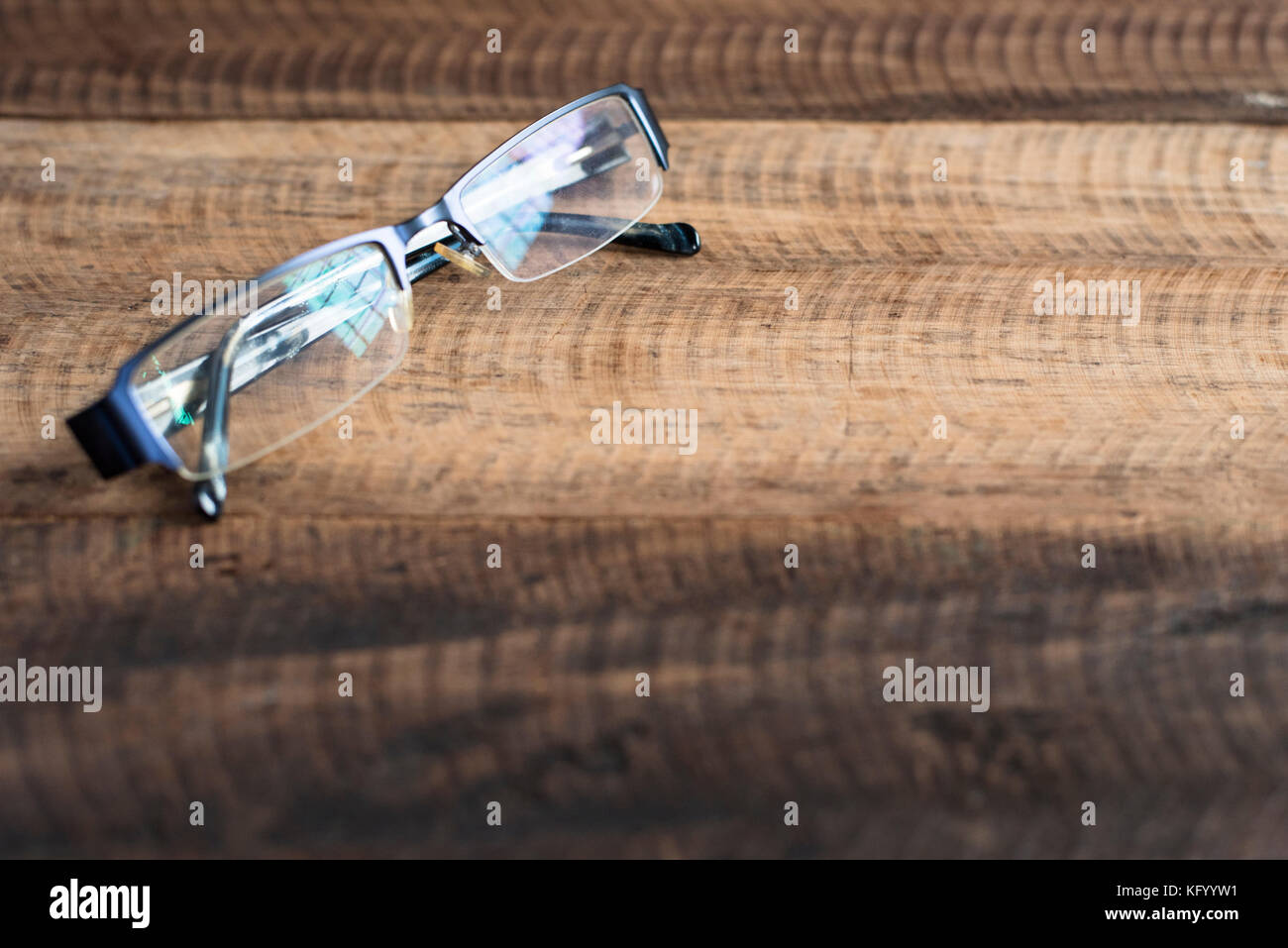 spectacle on a wooden background. spectacles with reflection of a window. image with copy space (selective focus) Stock Photo