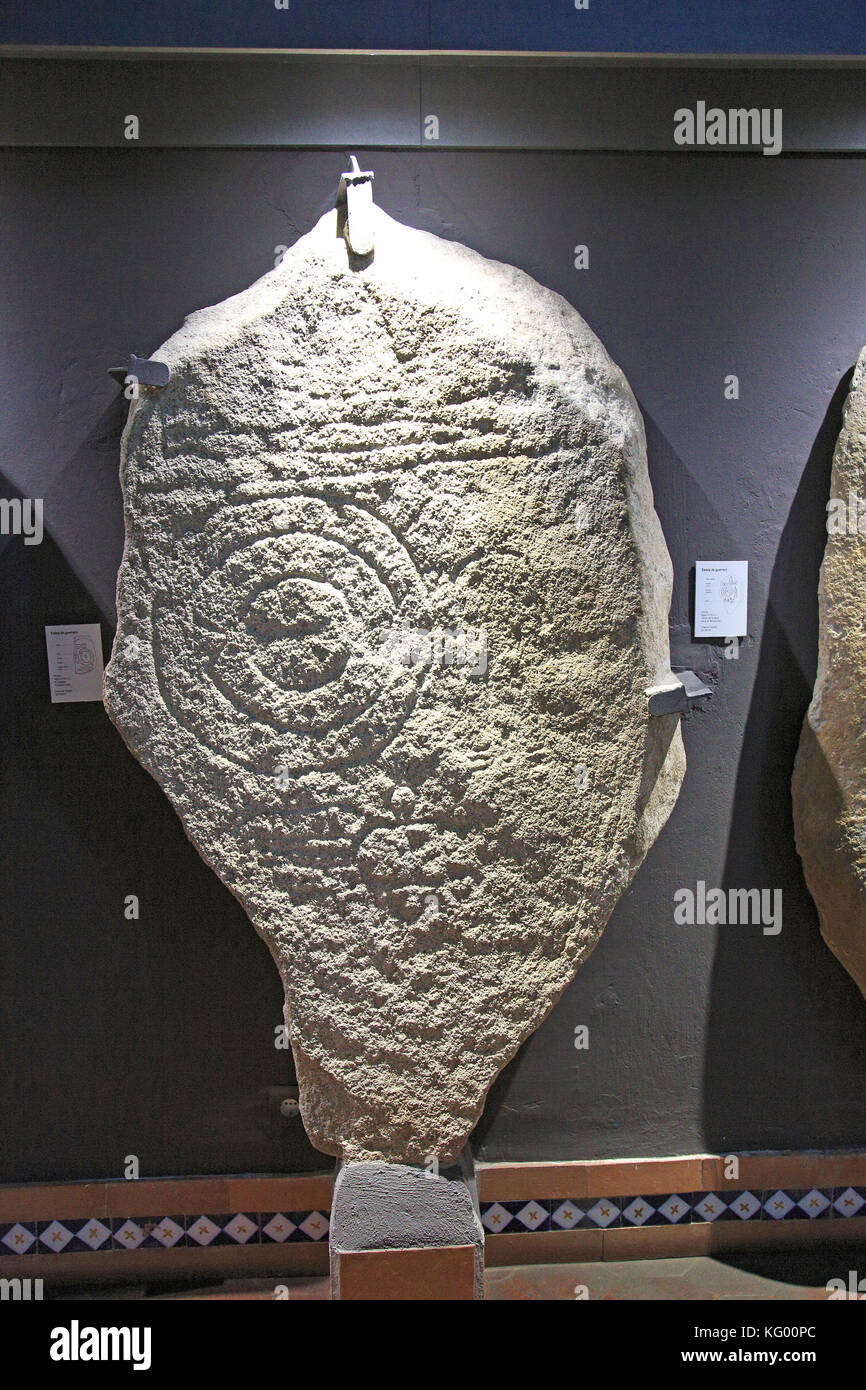 Bronze Age spiral patterns stone tablet in museum, Caceres, Extremadura, Spain Stock Photo