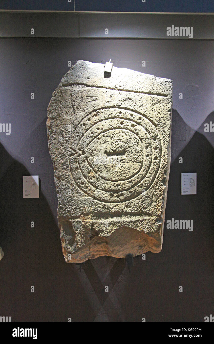 Bronze Age spiral patterns stone tablet in museum, Caceres, Extremadura, Spain Stock Photo