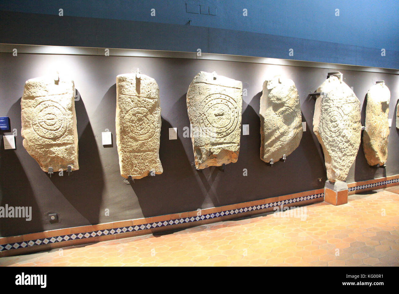 Bronze Age spiral patterns stone tablets in museum, Caceres, Extremadura, Spain Stock Photo
