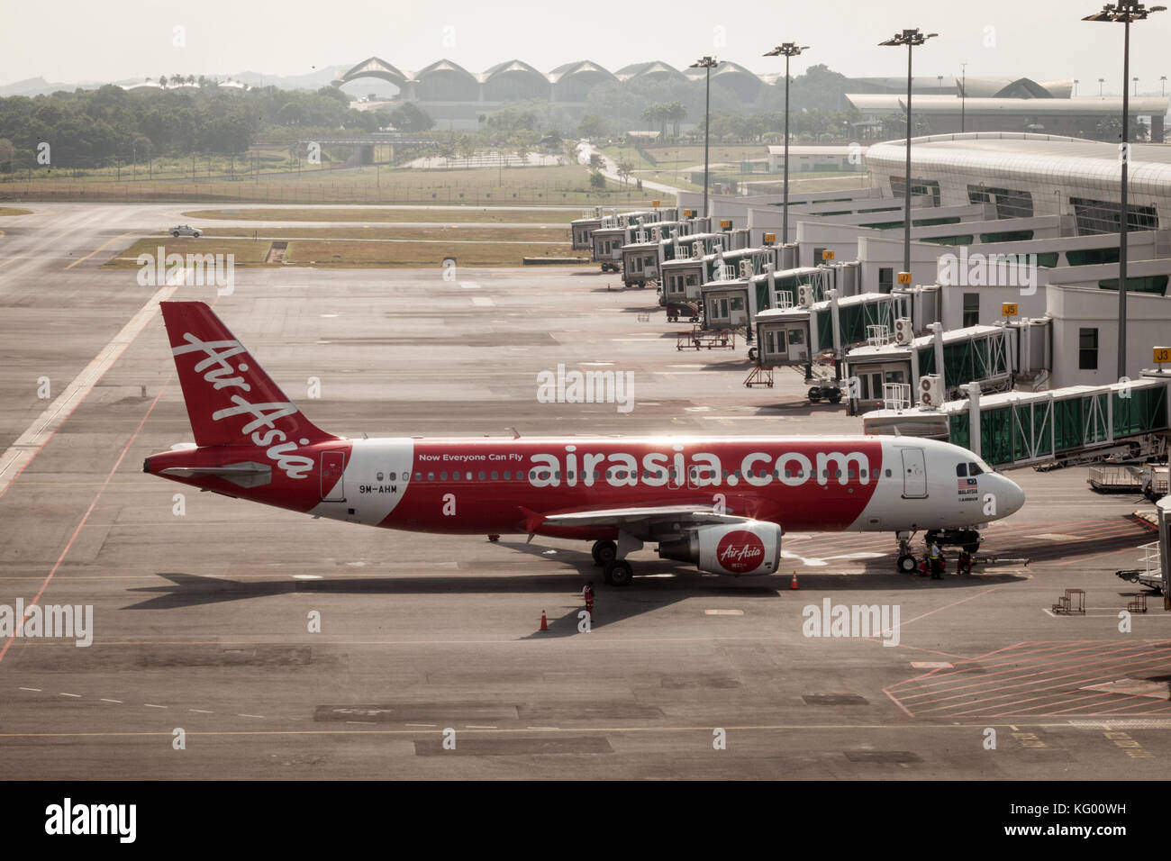 An AirAsia Bhd. A320 aircraft stands on the tarmac at Kuala Lumpur International Airport 2 (KLIA2) in Sepang, Selangor, Malaysia Stock Photo