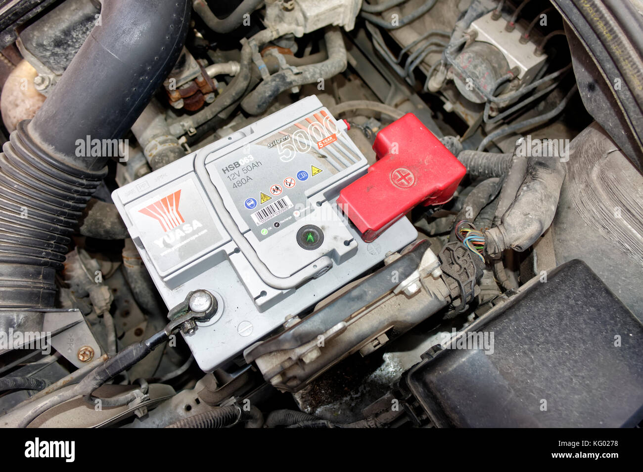 A Yuasa car battery in the engine bay of a 2006 Suzuki SX4 Stock Photo