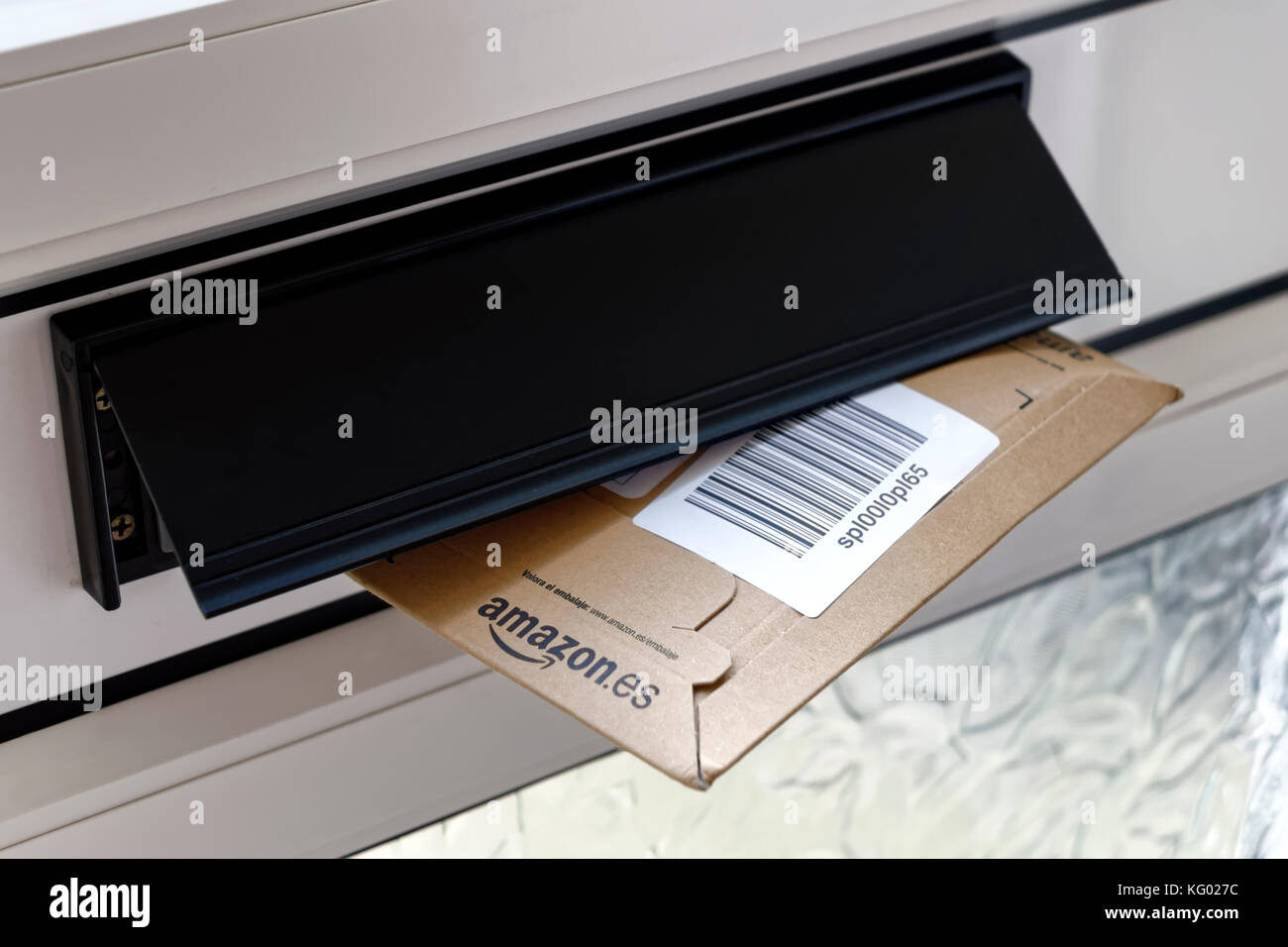 An Amazon parcel in a house letterbox in the United Kingdom Stock Photo