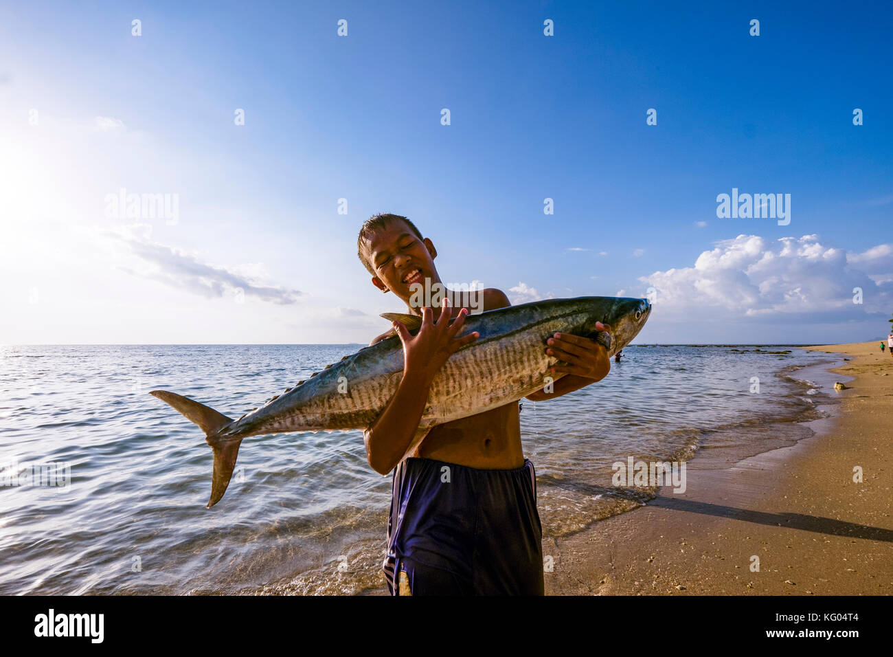 Thailand. Andaman Sea. Koh Lanta island. Young Fisherman carrying a swordfish Stock Photo