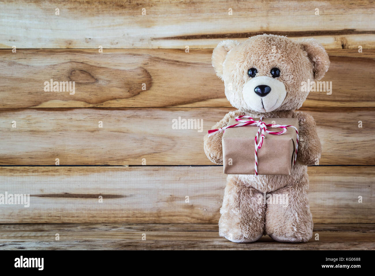 teddy bear holding a box