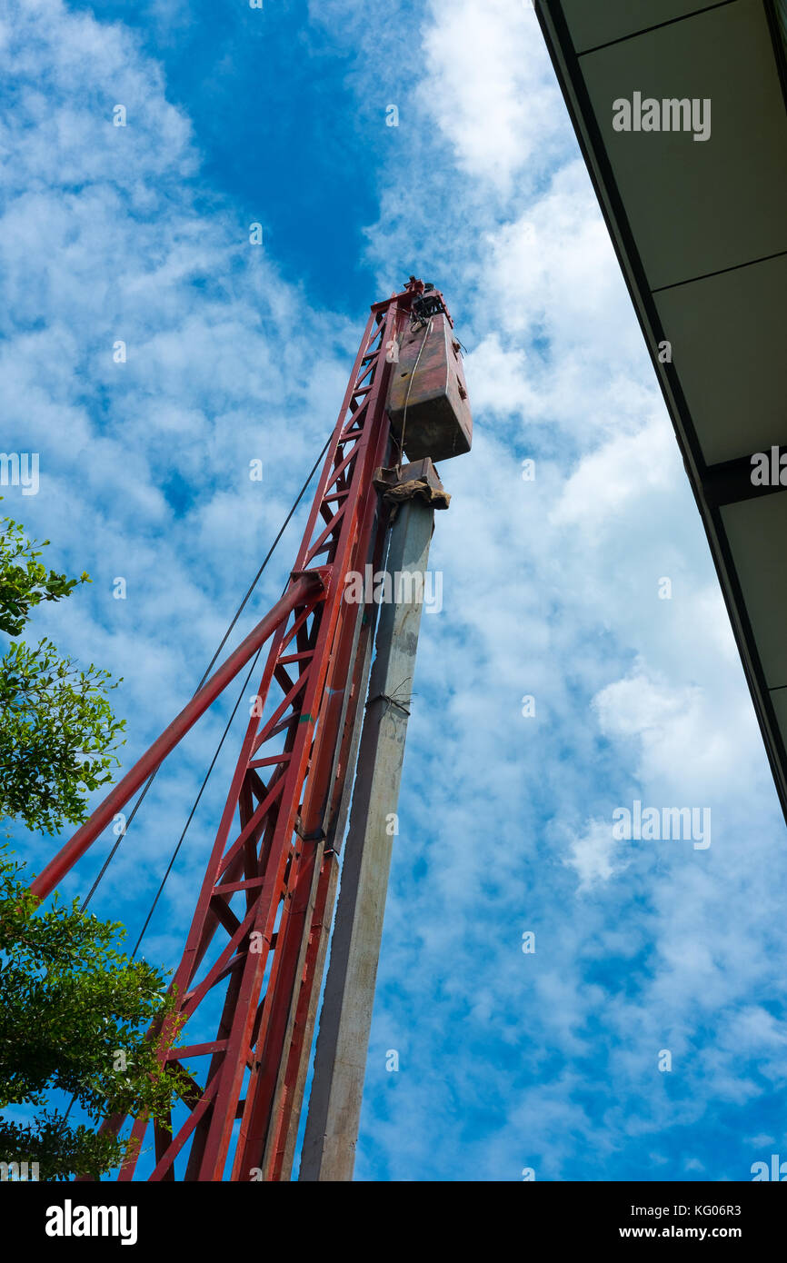 Pile driving crane doing lifting operation of piling rod at construction site Stock Photo