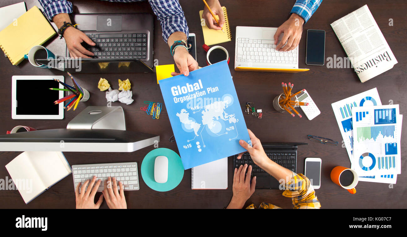 Group of Business People Working on an Office Desk Stock Photo - Alamy