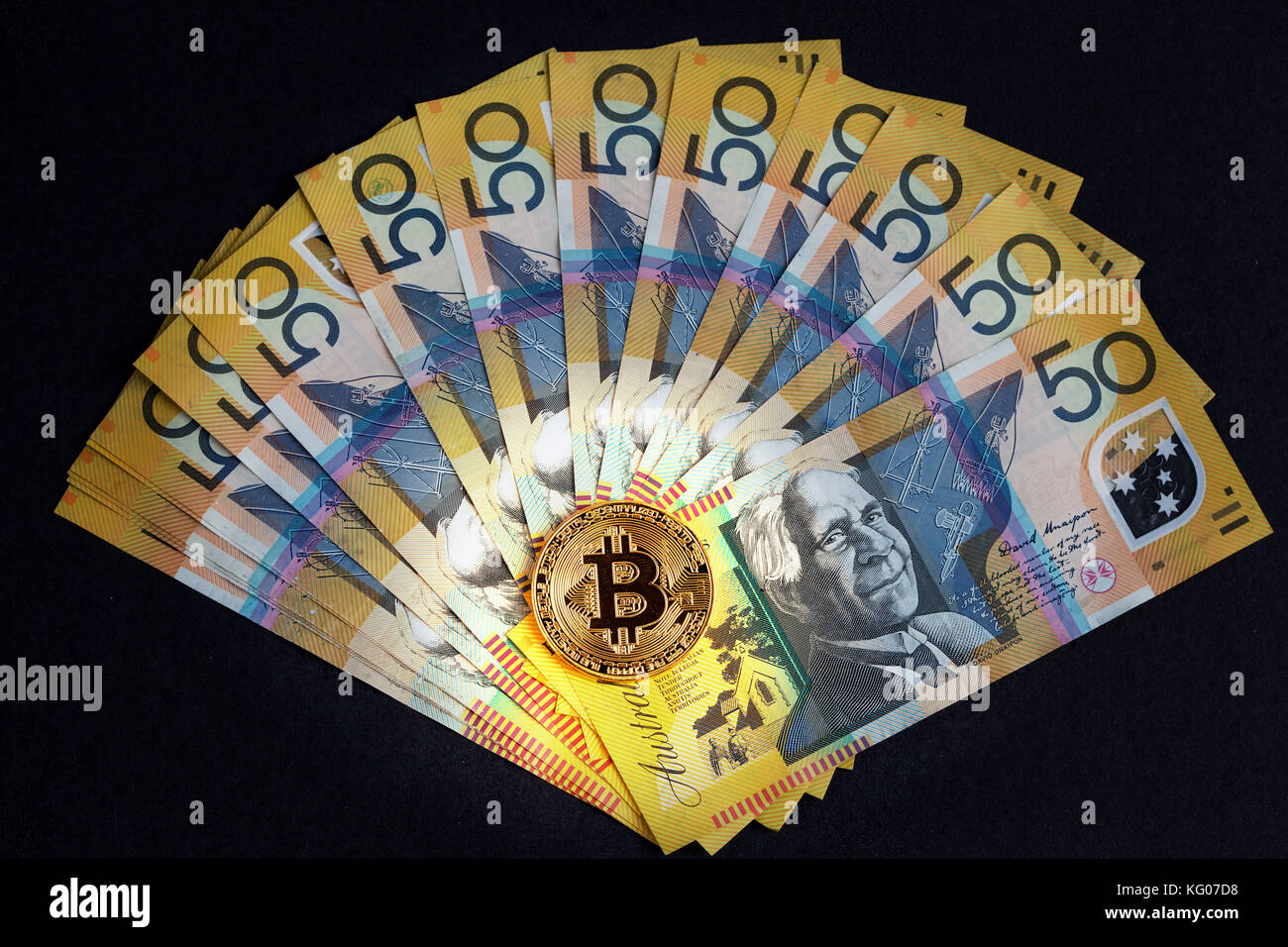 Golden Bitcoin glowing on top of Australian 50 dollar banknotes on black  background Stock Photo - Alamy