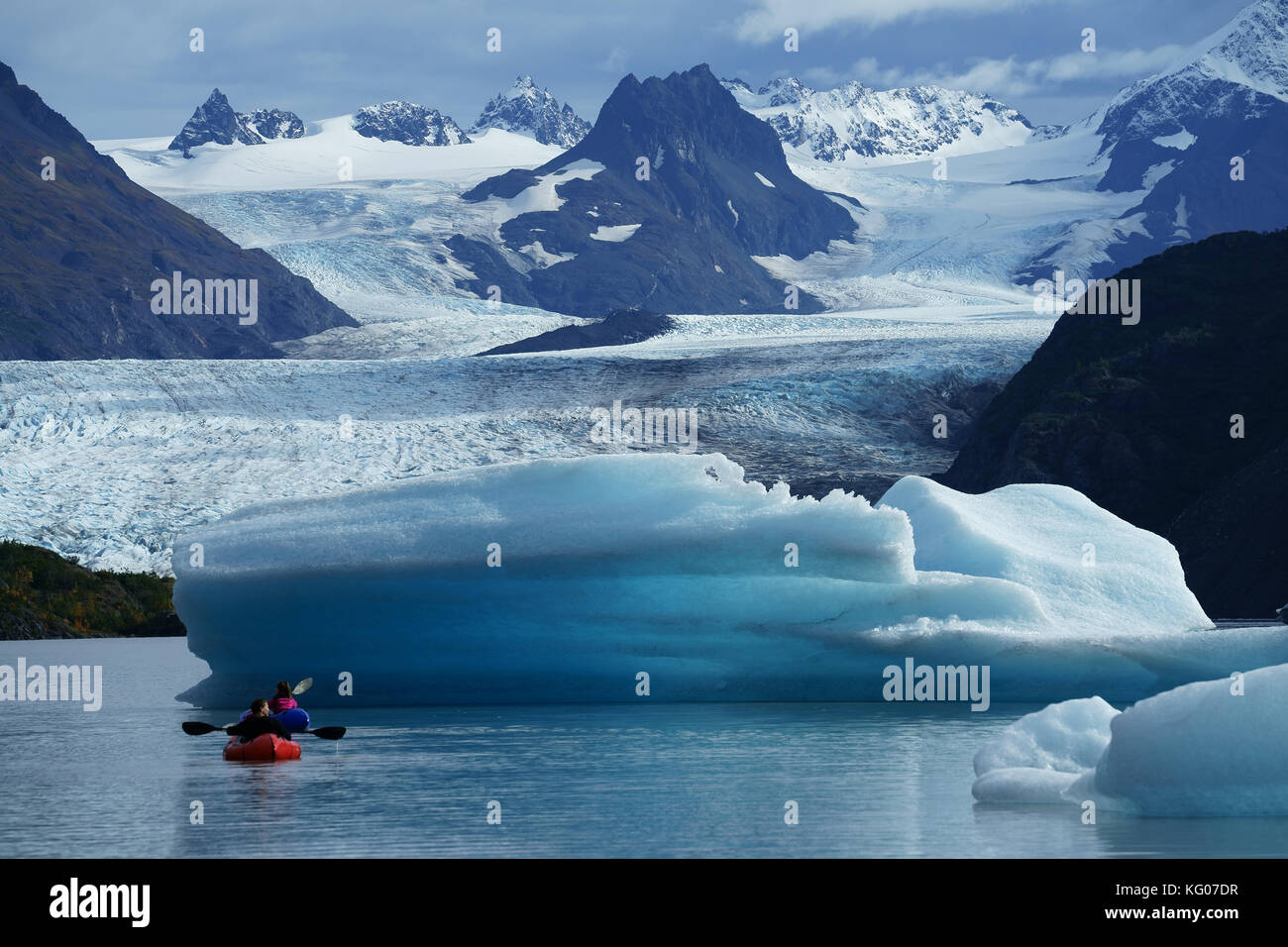 Kayaks on lake of Grewingk glacier with icebergs, Kenai Mountains, Kachemak Bay State Park, Alaska Stock Photo