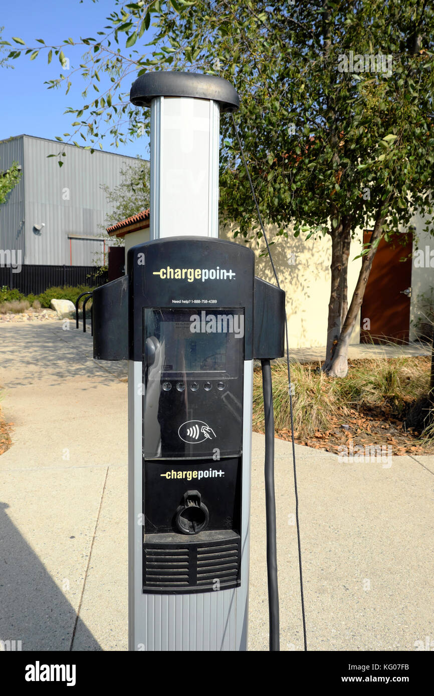 Fuel efficient small Fiat electric car recharging battery at charging