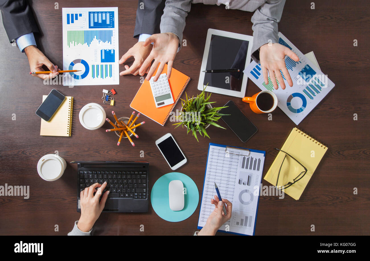 Group of Business People Working on an Office Desk Stock Photo - Alamy