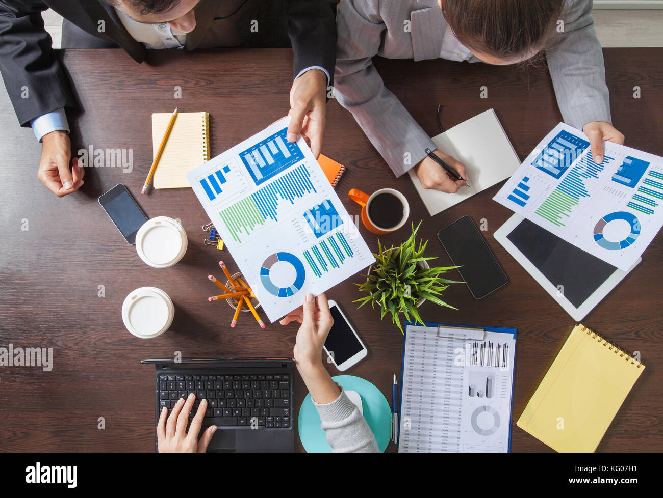 Group of Business People Working on an Office Desk Stock Photo - Alamy