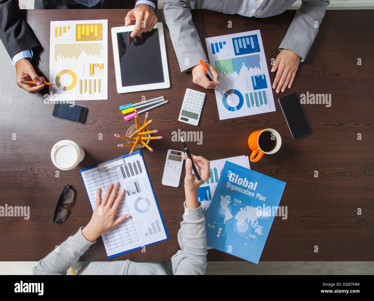 Group of Business People Working on an Office Desk Stock Photo - Alamy